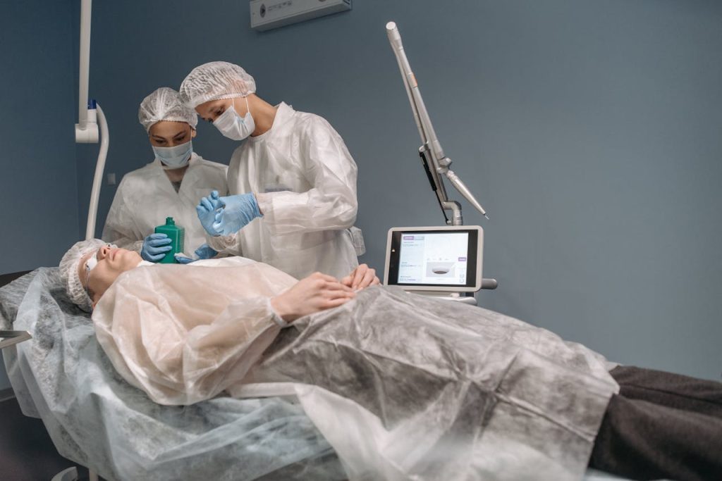Two doctors administering a cosmetic treatment to a patient in a clinic setting.